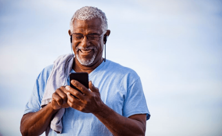 Man smiling while scrolling on mobile phone